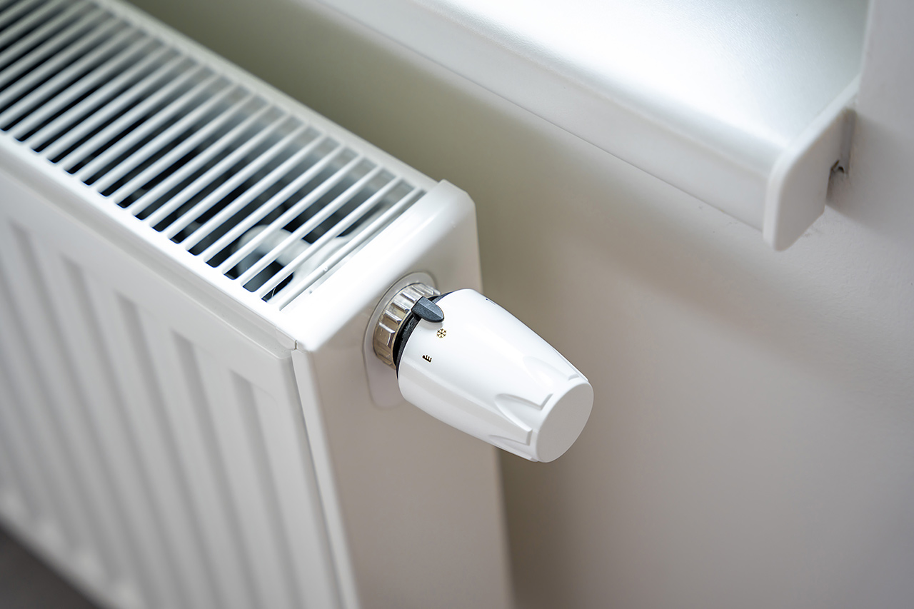 Modern panel radiator with thermostatic valve